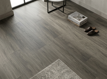 Congo SPC vinyl flooring, close view beside a side table, books and rug.
