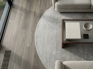 Congo SPC vinyl flooring, shown beside a round rug and glass coffee table.