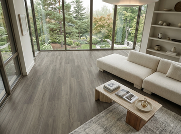 Congo SPC vinyl flooring, shown in a living room with a sectional sofa and garden windows.