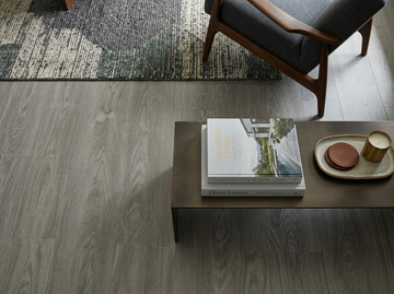 Everest SPC vinyl flooring, close view beside an armchair and coffee table.