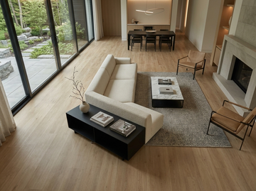 Caramel SPC vinyl flooring, shown in a living room with a fireplace and dining area.