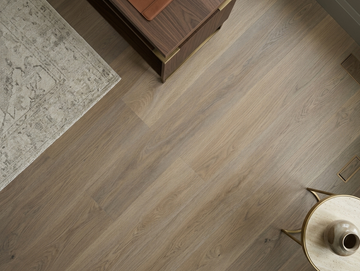 Cashmere SPC vinyl flooring, close view beside a rug and wooden coffee table.