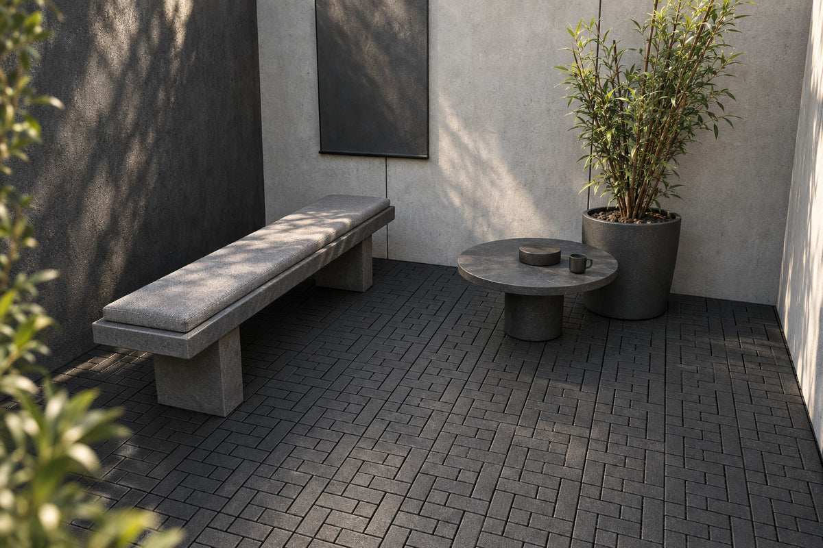 Black interlocking composite deck tiles in a sculptural courtyard; AI installation visualization guided by the product’s 3D tile model.