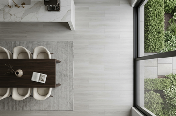 Cornsilk SPC vinyl flooring, overhead view beside a dark dining table and garden windows.