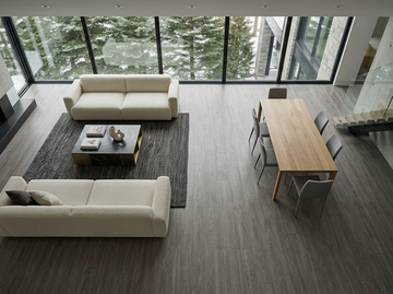 Everest SPC vinyl flooring, shown in a living and dining area with white sofas.