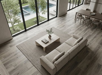 Floating Ice SPC vinyl flooring, shown in a living and dining area beside garden windows.