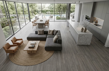 Mink SPC vinyl flooring, shown in an open kitchen and living area around a circular rug.