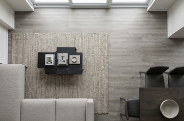 Mink SPC vinyl flooring, overhead view of a seating area beside a dining table.