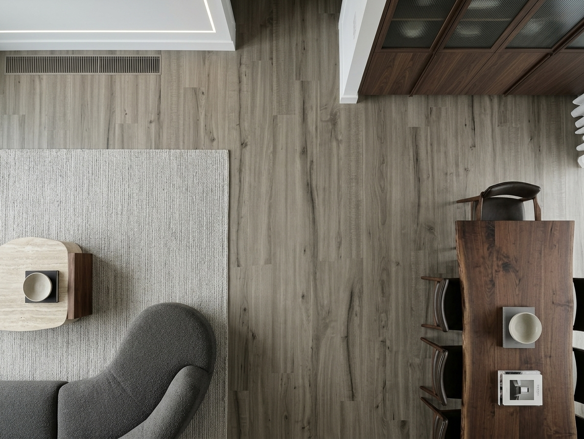 Pebble SPC vinyl flooring, overhead view between a seating area and dining table.
