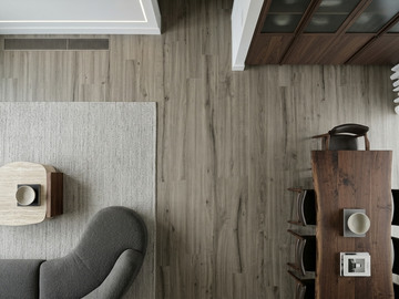 Pebble SPC vinyl flooring, overhead view between a seating area and dining table.